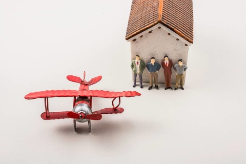 Airplane and tiny figurine of man miniature model in view