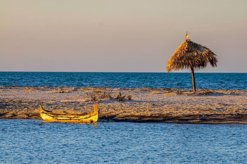Little sailing boat on a sand tongue below the Antsanitia beach resort near Mahajanga