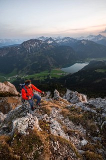 Hiker at the summit of Schartschrofen at sunset