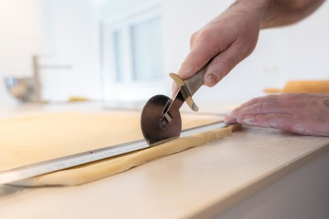 Confectioner man baking homemade croissants