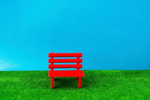 Little red miniature bench made of plastic