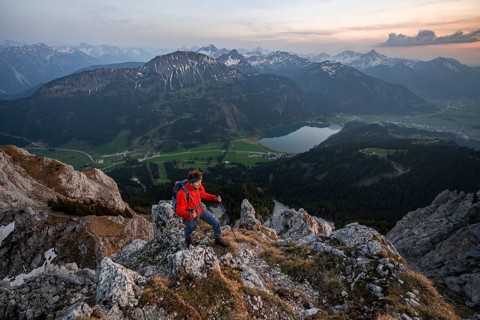Hiker at the summit of Schartschrofen at sunset