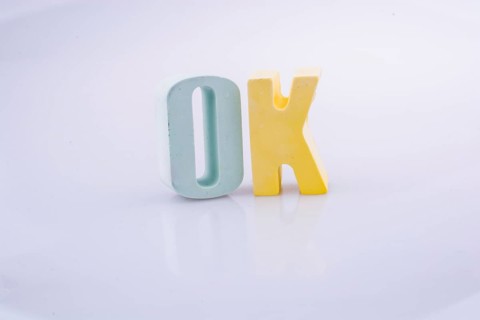 The word OK written with colorful letter blocks