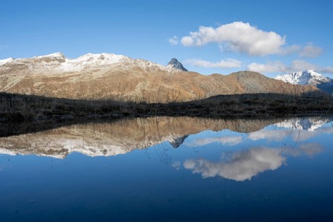 Reflection and view of the mountains at the Bernina Pass