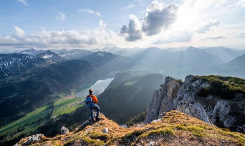 Hiker at the summit of Schartschrofen at sunset