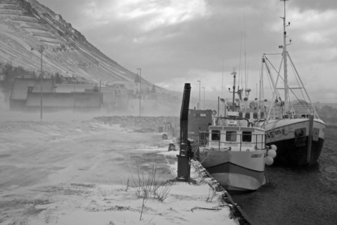 Fishermen lying at the harbour on a stormy day