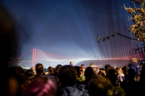 Crowd watch fireworks show over the Istanbul City View of Bosporus Bridge