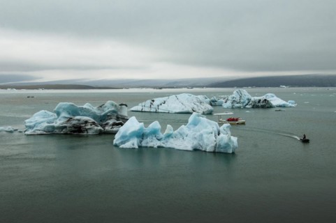 Icebergs and excursion boat in the Joekulsarlon glacier lagoon