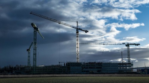 Construction cranes on a building site in Augsburg on the Bundesstrasse 17