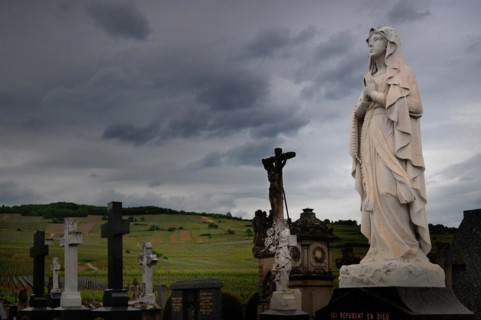 Praying statue of the Virgin Mary in a cemetery