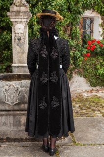 Rear view of a stylish woman in a shawl