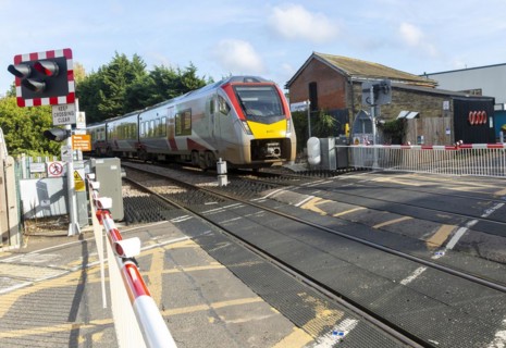 Abellio Greater Anglia Class 755 Stadler bi-modal train at level crossing