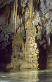 Limestone formations of karst rock above Stalagtites below Stalagmites grow together in dripstone cave