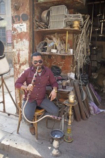 Egyptian man with sunglasses smoking a shisha or hookah