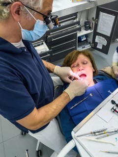 Dentist examines patients dentition
