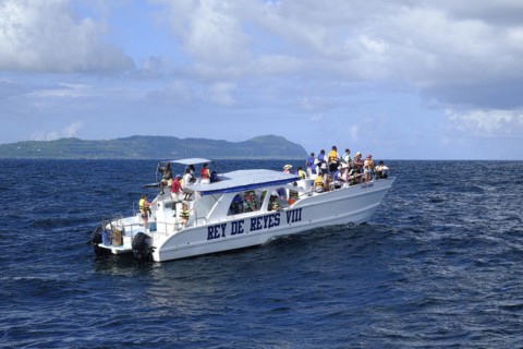 Tourists on a whale watching boat in Samana Bay