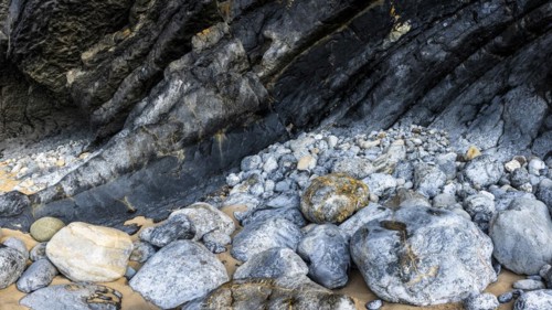Rocky coast and colourful stones at Praia da Adraga