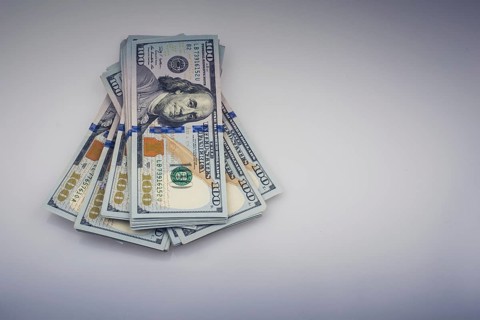American 100 dollar banknote bundles placed on white background