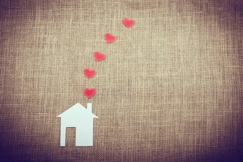 Heart shape coming out of chimney of paper house