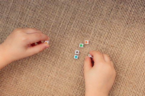 Little cubes with heart shape in hand on canvas