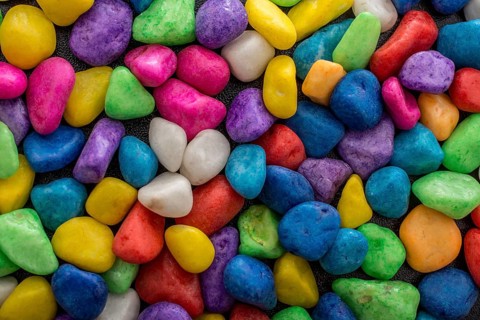 Pile of little colorful pebbles as stone background