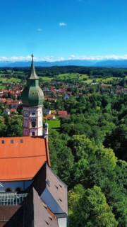 Aerial view of Andechs Monastery with the Alps in the background. Andechs