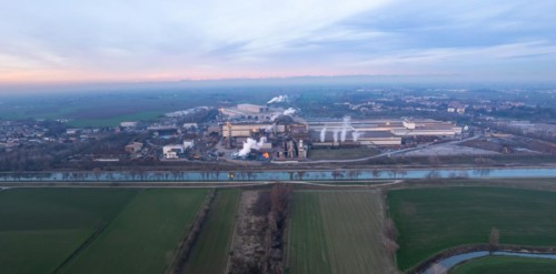 Drone aerial view of working steel plant at dawn