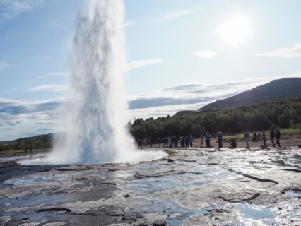 Tourists watching a geyser erupt