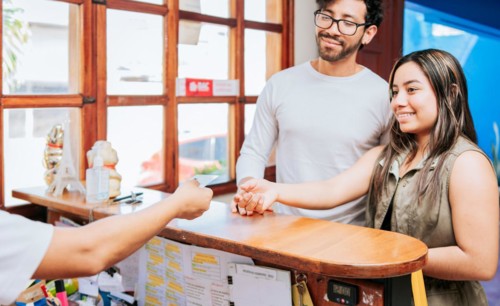 Couple receiving hotel room keys