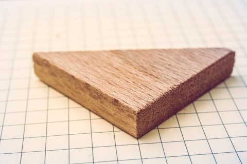 Piece of wood in the shpae of a triangle on paper