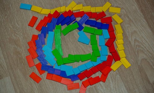 Colorful Domino Blocks in a line on a white background