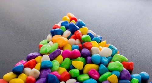 Pile of little colorful pebbles as stone background