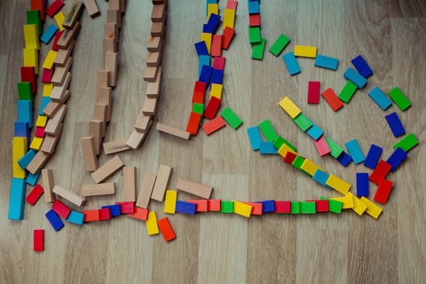 Colorful Domino Blocks in a line on a white background