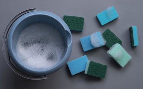 Many cleaning sponges with cleaning bucket and foam