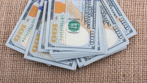 Banknote bundle of US dollar placed on a linen canvas