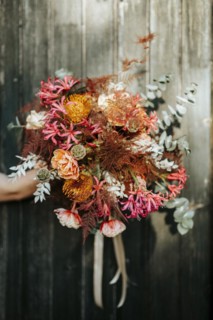 Beautiful rustic bouquet hold on wooden door background