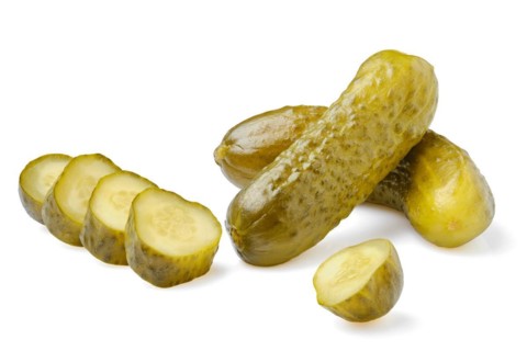 Pickled cucumbers whole and sliced isolated on white background