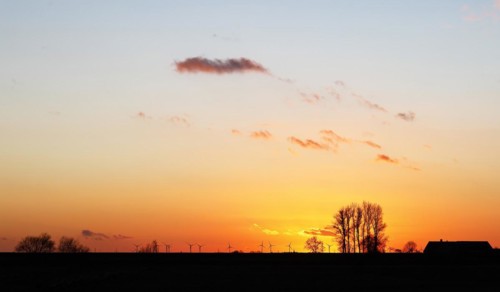 Dramatic evening sky with sunset over the Elbe dike near Faehrmannssand