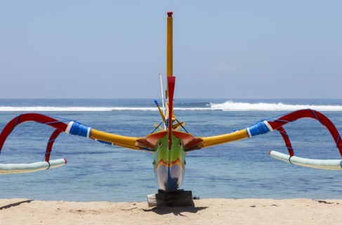 Brightly painted fishing outriggers on the beach at Sanur