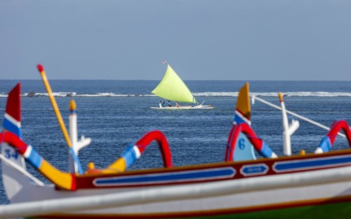 Brightly painted fishing outriggers on the beach at Sanur