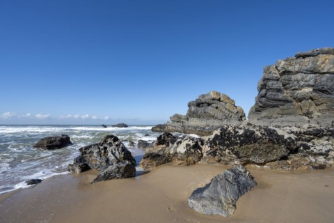 Rocky coast and sandy beach at Praia da Adraga