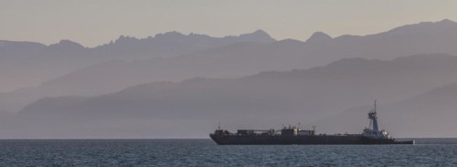 A cargo ship passes the Spit near Homer