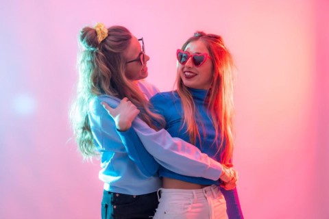 Two young blonde caucasian women dancing in nightclub