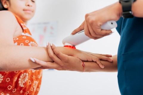 Laser therapy used on the arm to treat pain