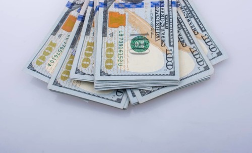 American 100 dollar banknote bundles placed on white background