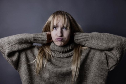 Young woman with long blond hair and a woollen jumper