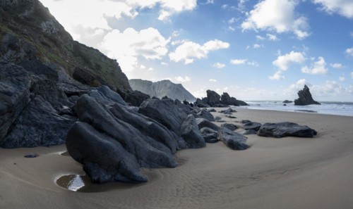 Rocky coast and sandy beach at Praia da Adraga