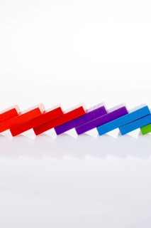 Colorful Domino Blocks in a line on a white background