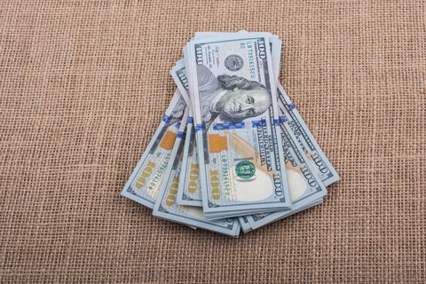 Banknote bundle of US dollar placed on a linen canvas