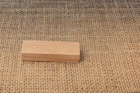 Wooden domino on a linen canvas background